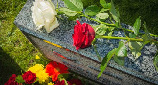 GettyImages-1069602848-grave-flowers